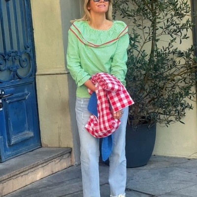 Mulher com blusa verde de padrão xadrez e ténis verdes em rua