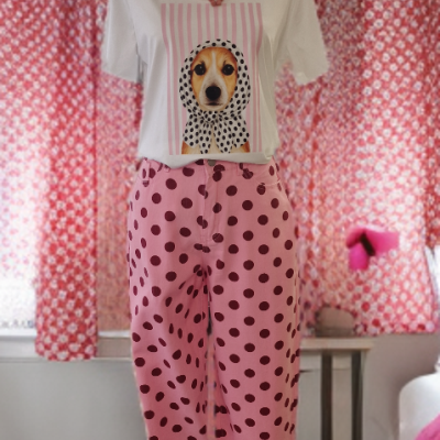 Mannequim com t-shirt branca estampada, calças cor-de-rosa às bolinhas e colar rosa