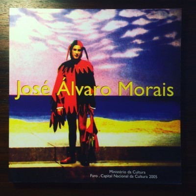 Capa de livro com pessoa em traje colorido vermelho e preto e texto José Álvaro Morais
