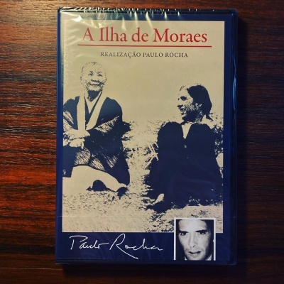 Capa do livro 'A Ilha de Moraes' com imagem a preto e branco de duas pessoas e assinatura de Paulo Rocha