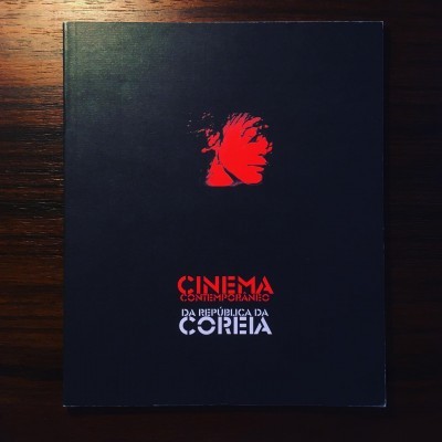 Capa de livro preta com rosto vermelho e texto CINEMA CONTEMPORÂNEO DA REPÚBLICA DA COREIA
