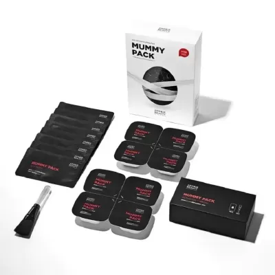 Kit de produtos MUMMY PACK com embalagens pretas e brancas e pincel
