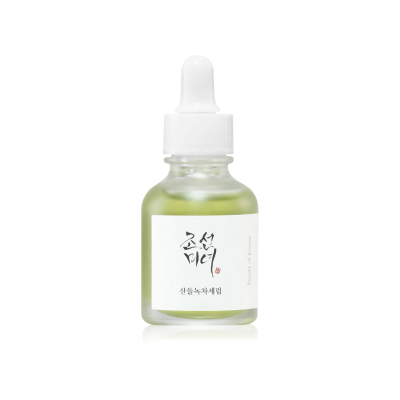 Frasco pequeno de vidro com tampa conta-gotas branca e líquido verde esmeralda