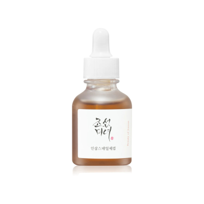 Frasco pequeno com conta-gotas branco, rótulo em coreano e líquido âmbar