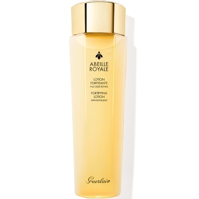 Frasco amarelo translúcido com tampa dourada de loção Abeille Royale da Guerlain