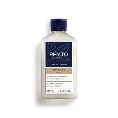 Frasco de champô reparador PHYTO de 250 ml com rótulo azul, bege e branco e tampa azul escura.