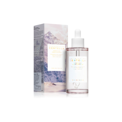 Frasco de sérum rosado com conta-gotas e embalagem com imagem de montanha