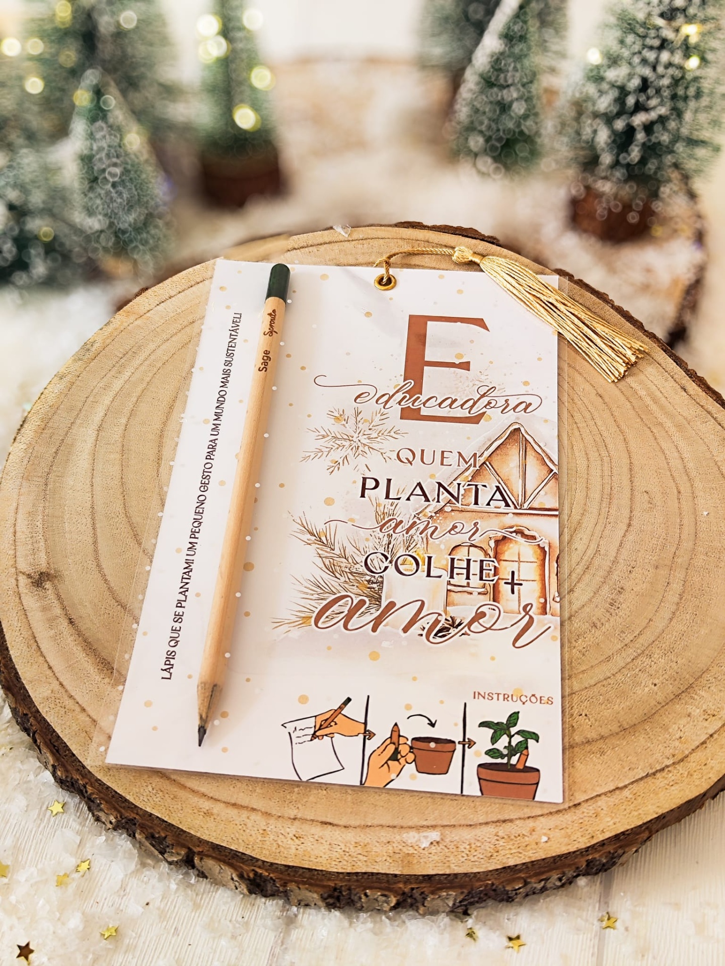 Cartão decorativo com lápis sobre tronco de madeira e árvores de Natal ao fundo