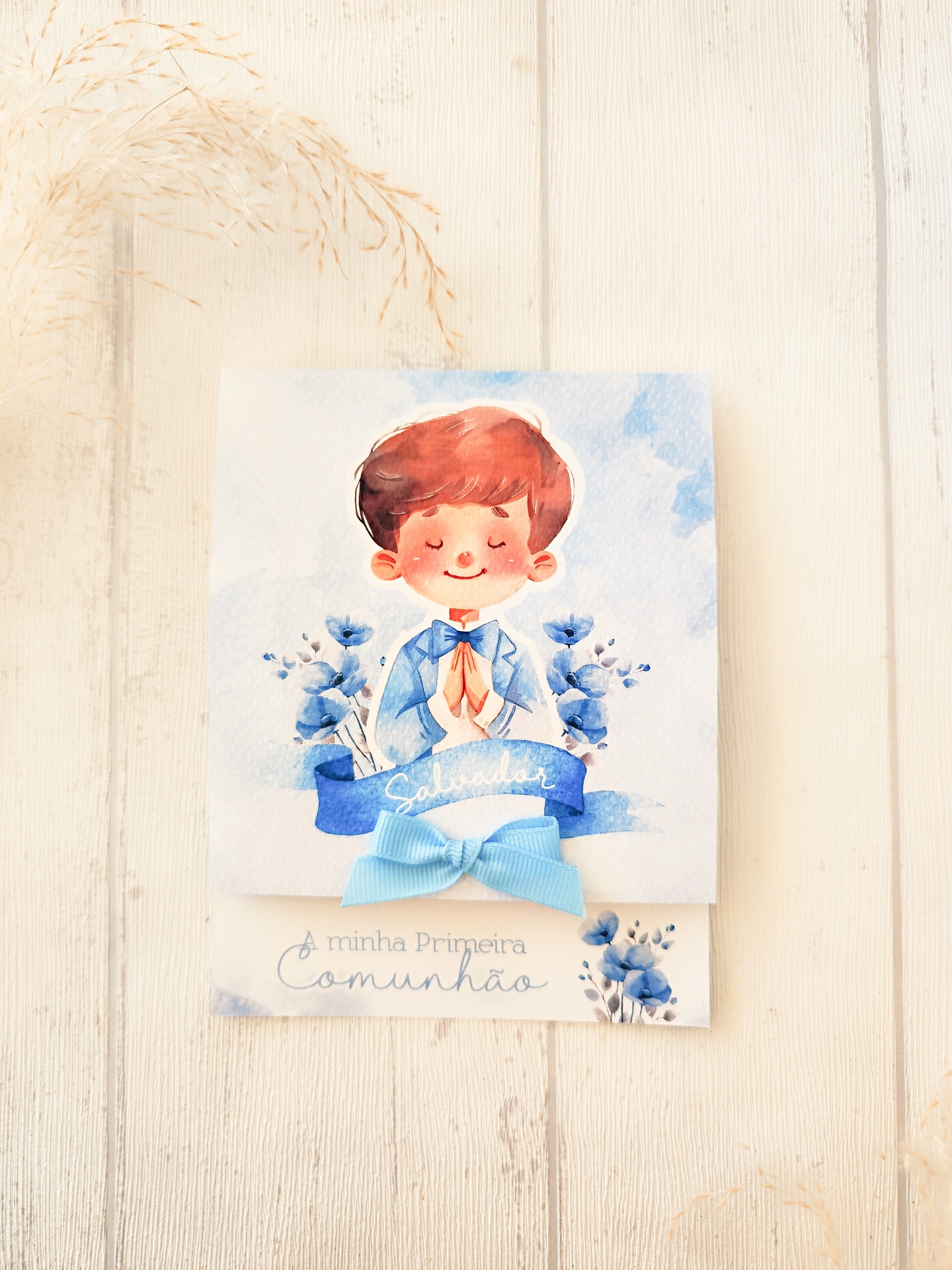 Convite de Primeira Comunhão com ilustração de criança a rezar e decorações azuis