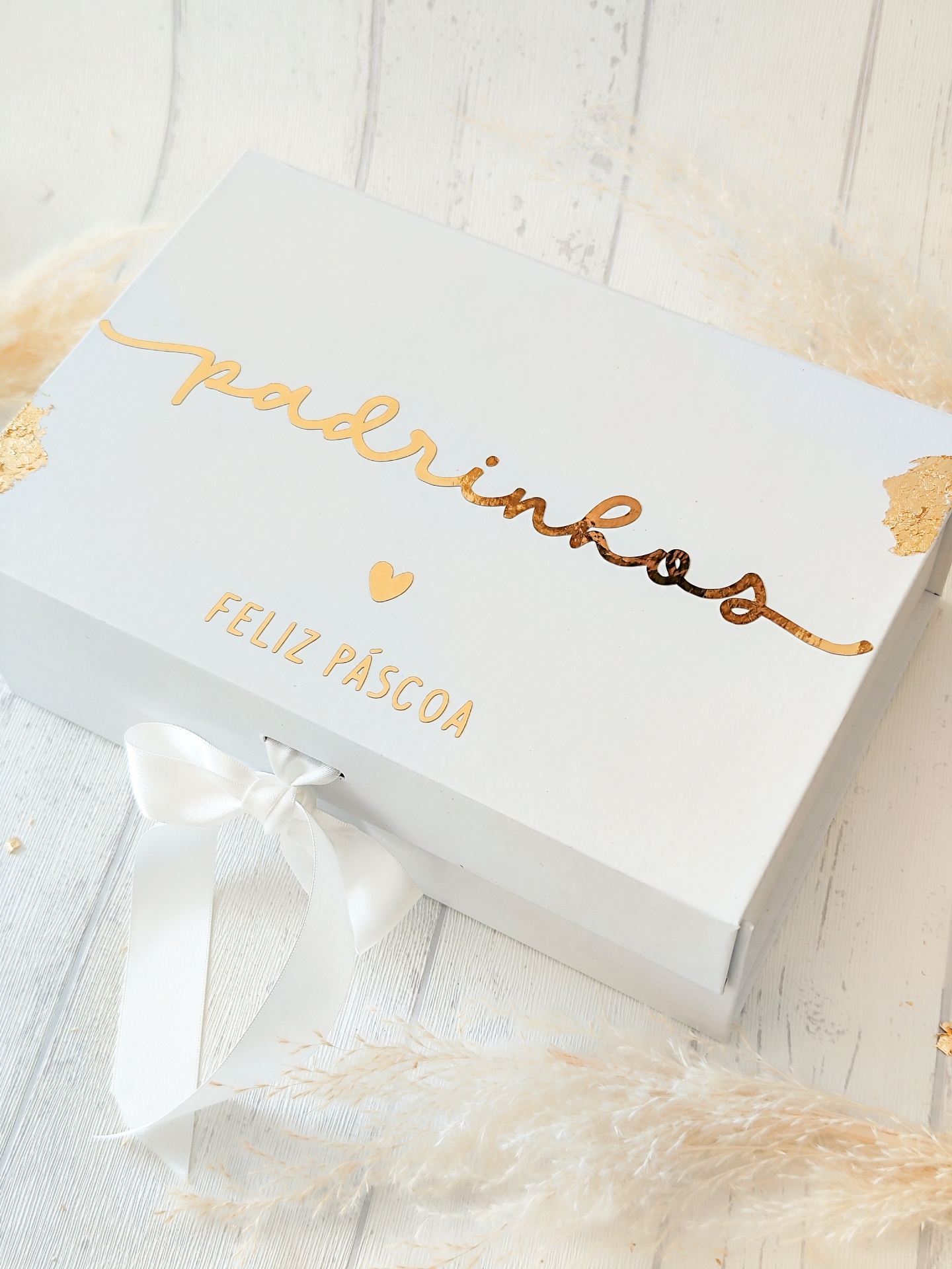 Caixa branca decorativa com textos dourados e laço branco
