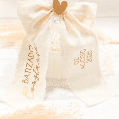 Garrafa de vidro com laço bege e texto dourado para batizado