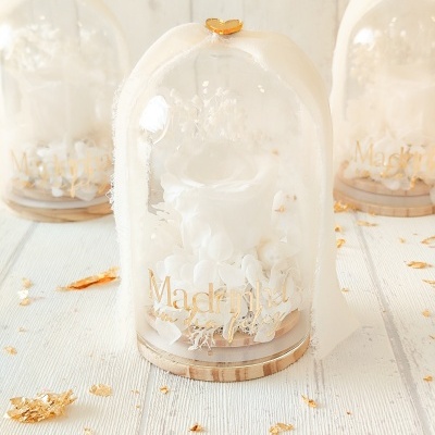 Arranjos florais em cúpulas de vidro com texto Madrinha um dia feliz e decoração branca e dourada