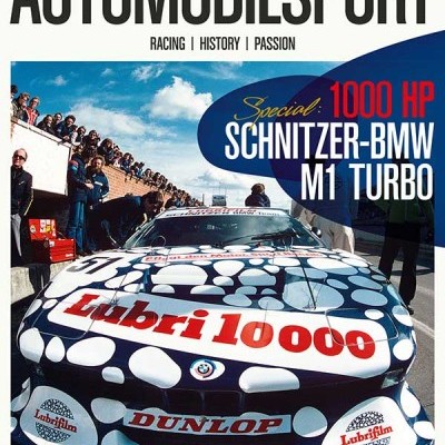 Revista AUTOMOBILSPORT com carro de corrida BMW M1 Turbo com padrão de círculos brancos e textos Lubri 10000 e Dunlop na frente.