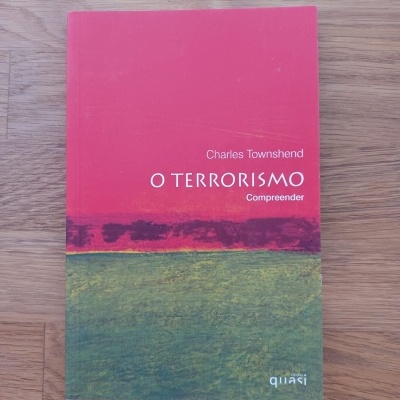 Livro 'O TERRORISMO Compreender' de Charles Townshend numa superfície de madeira