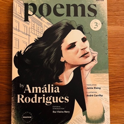 Capa de livro poems by Amália Rodrigues com ilustração de mulher e detalhes textuais.