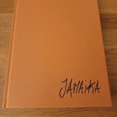 Livro de capa dura castanha com título JamaiKa em letra manuscrita