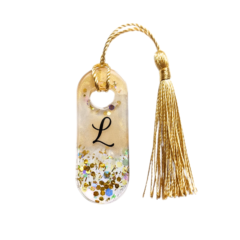 Marcador de livros transparente com glitter e letra L, com tassel dourado