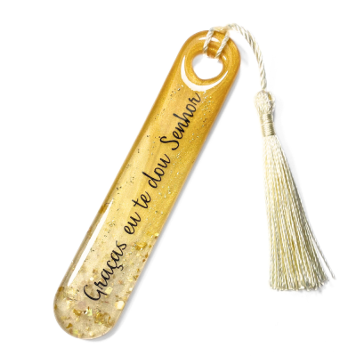 Marcador de páginas transparente com partículas douradas e tassel branco