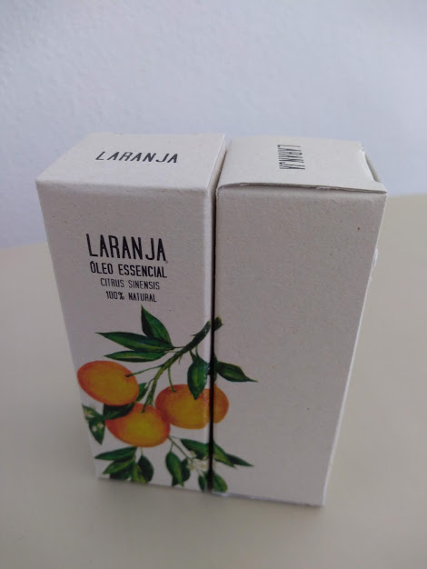 Caixa de óleo essencial de laranja com ilustração de laranjas e texto preto