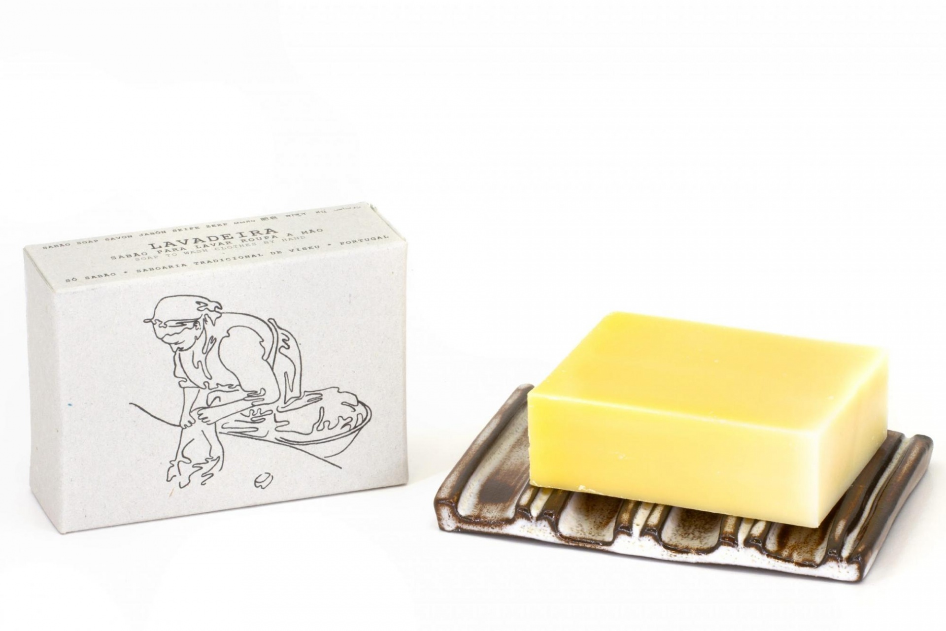 Sabonete amarelo em suporte ao lado de caixa branca com ilustração