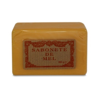 Barra de sabonete de mel laranja com etiqueta castanha e texto vermelho