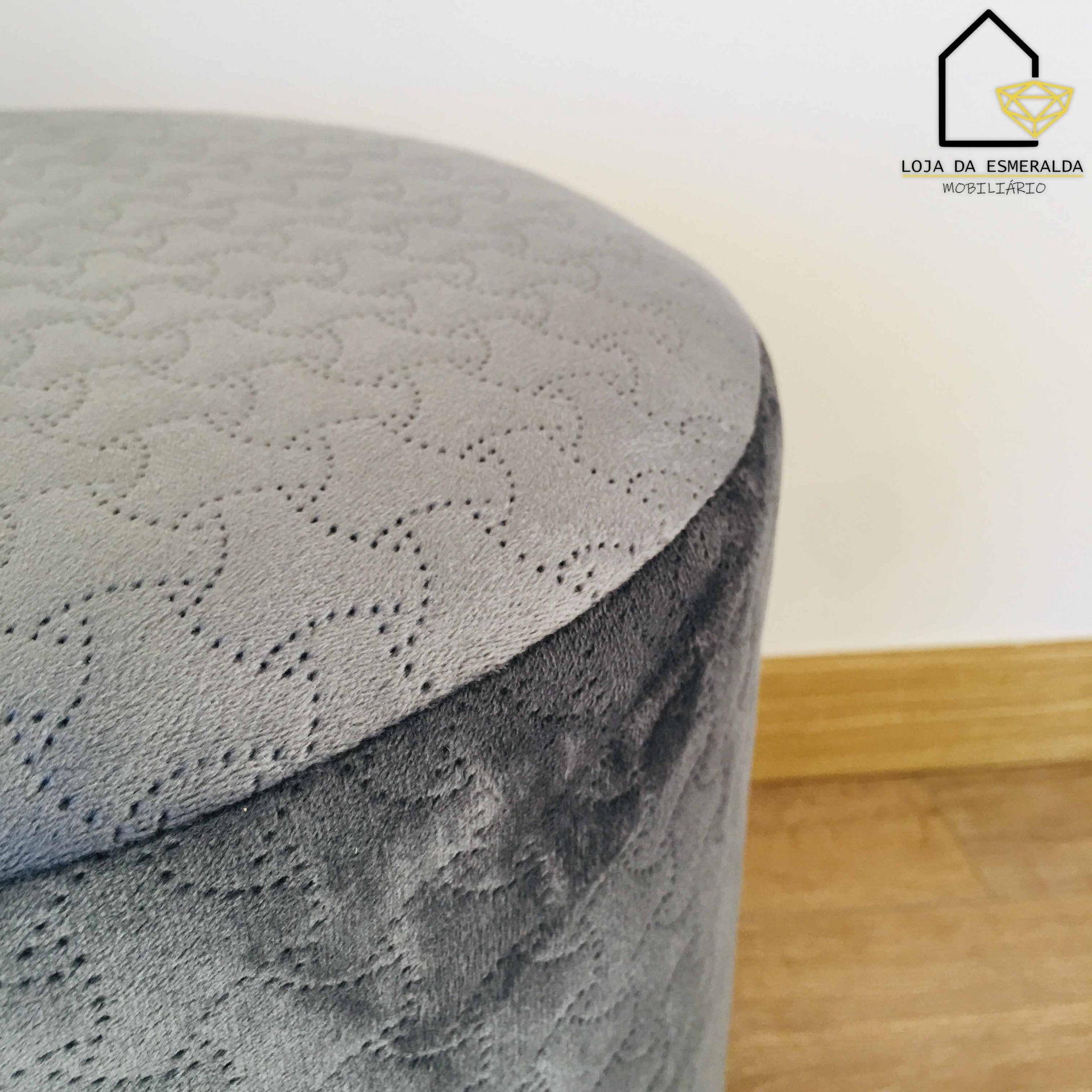 Pufe redondo cinzento com padrão ondulado e textura macia