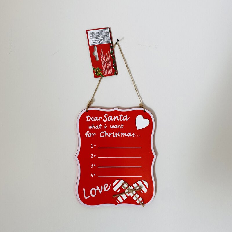 Placa decorativa vermelha com texto para lista de desejos de Natal e decoração de bastões doces.