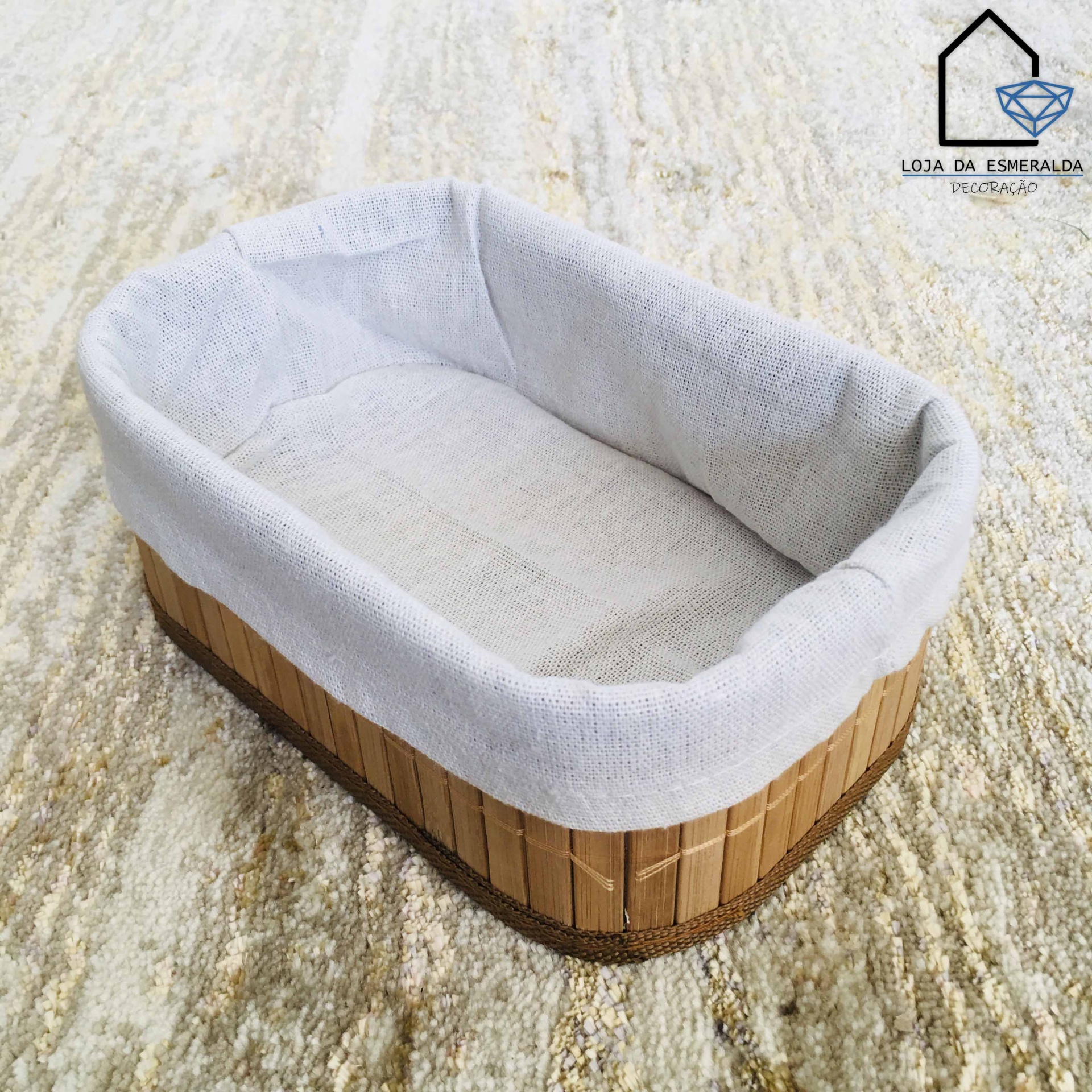 Cesto de madeira com forro branco sobre tapete bege