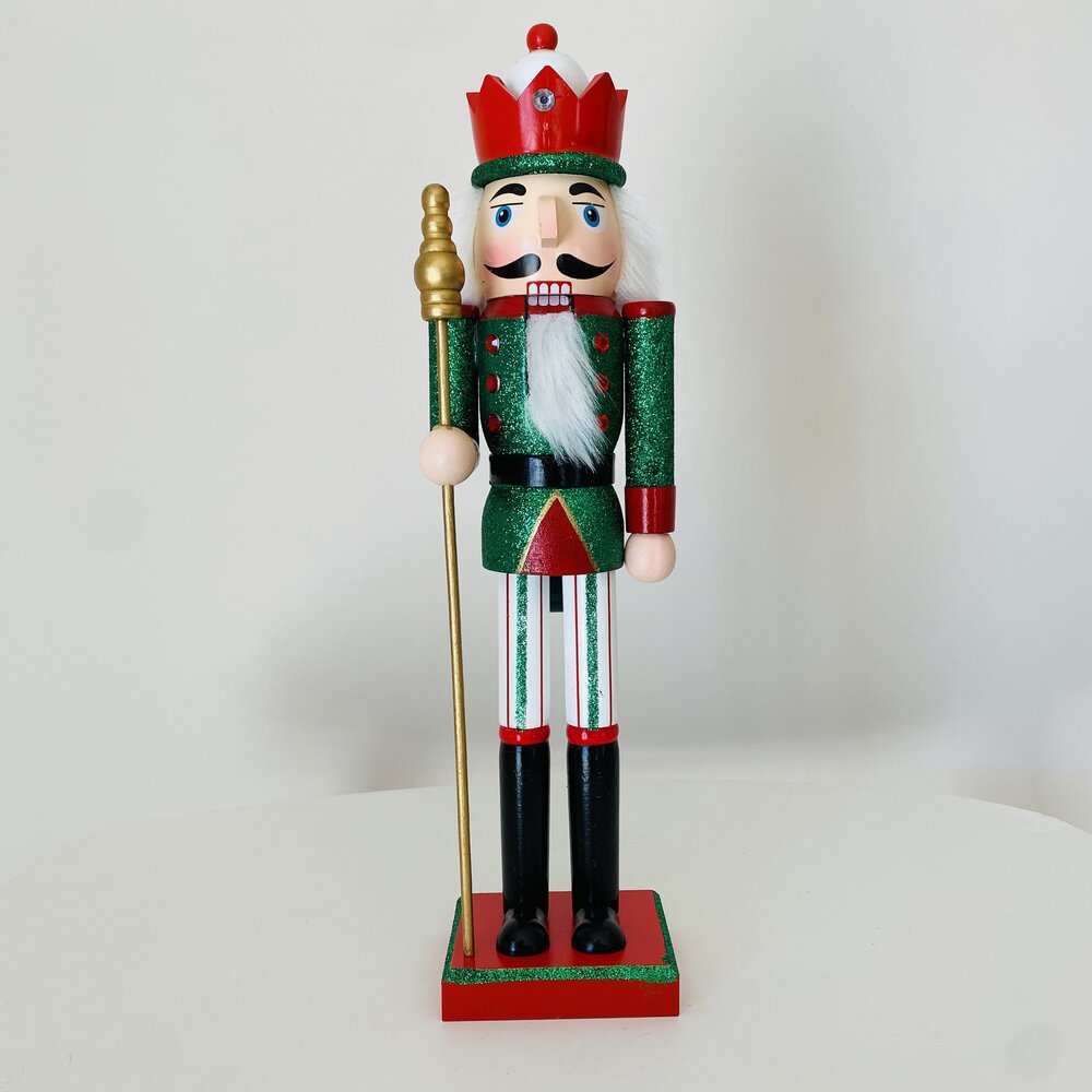 Boneco Quebra-Nozes decorativo em madeira verde e vermelha com cetro.