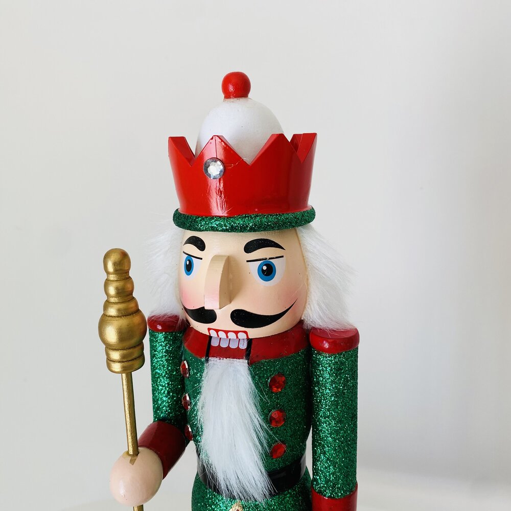 Boneco de soldado quebra-nozes verde brilhante com coroa vermelha e cetro dourado