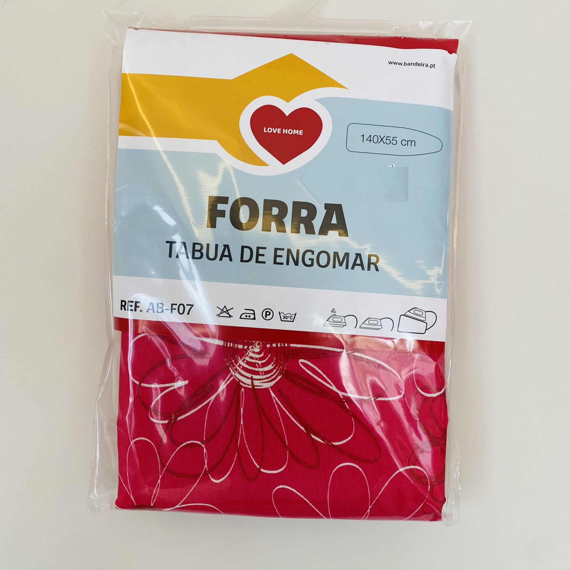 Forra vermelha para tábua de engomar com padrão branco, embalada com rótulo azul e amarelo