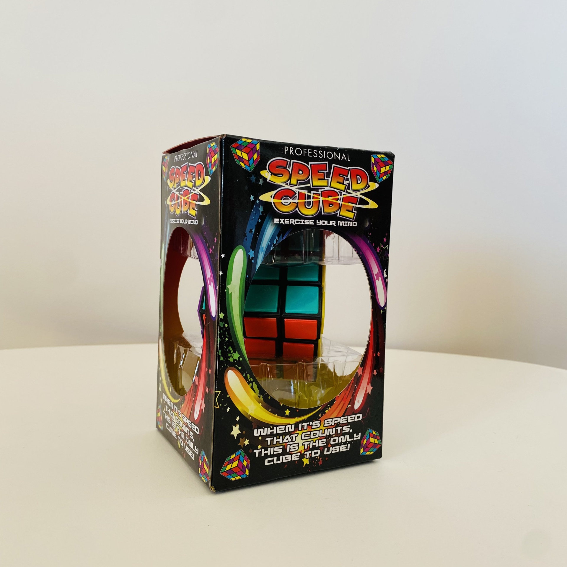Embalagem preta de cubo mágico profissional com cubo colorido visível dentro.