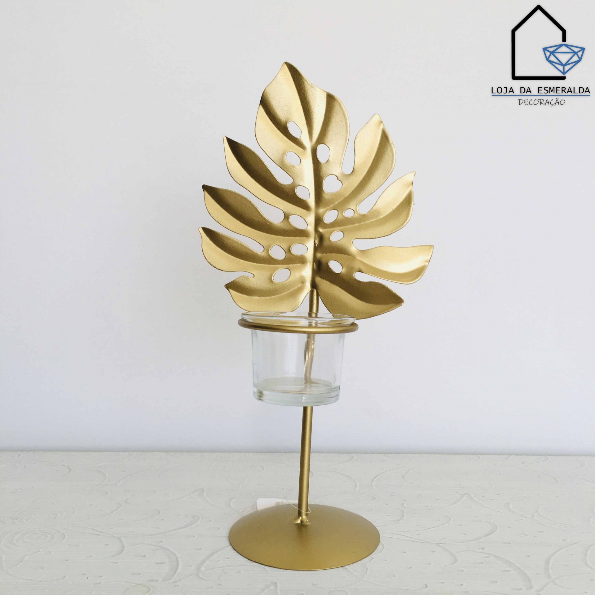 Suporte decorativo dourado com folha e frasco de vidro