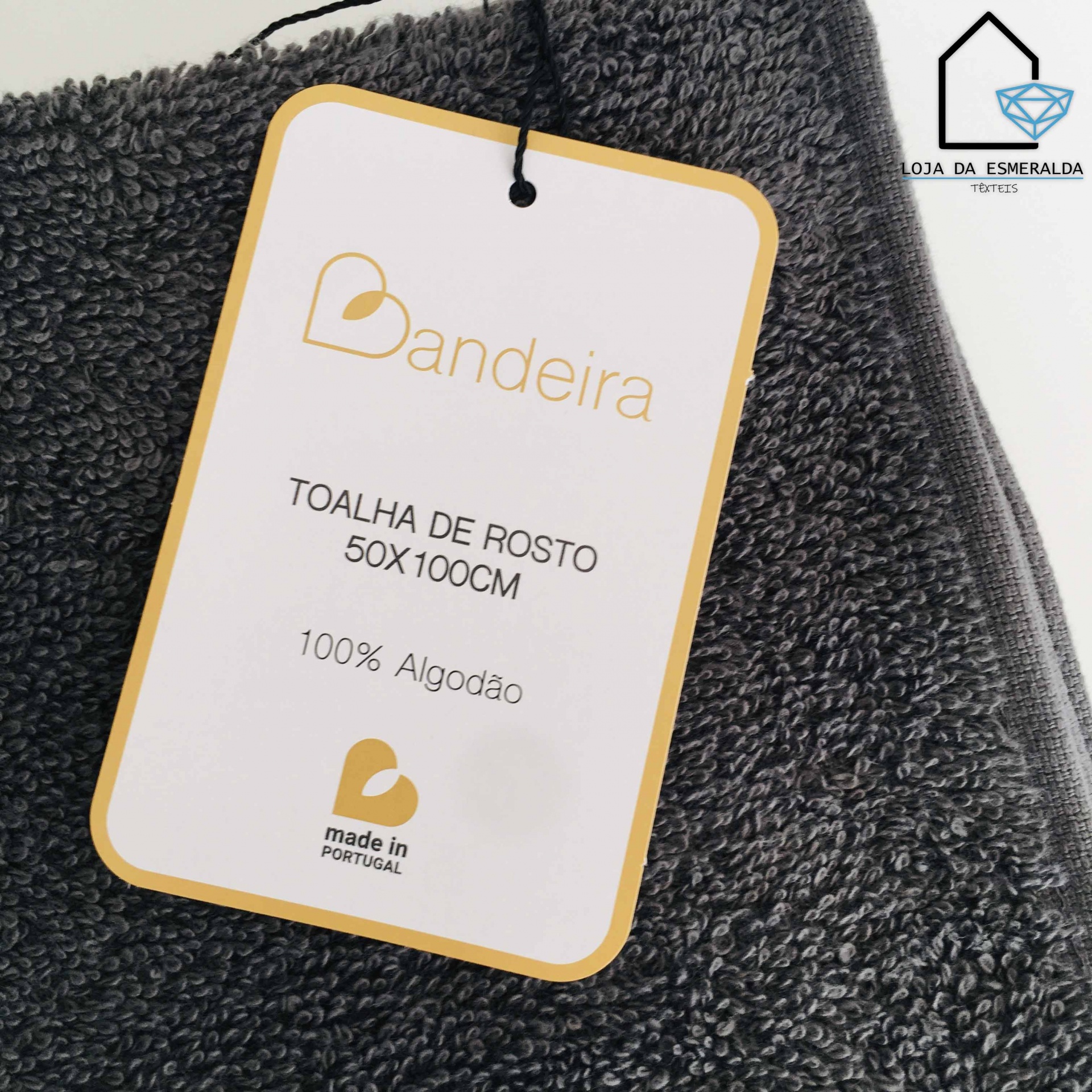 Toalha de rosto cinzenta escura com etiqueta Branco com texto da marca Bandeira e informações do produto