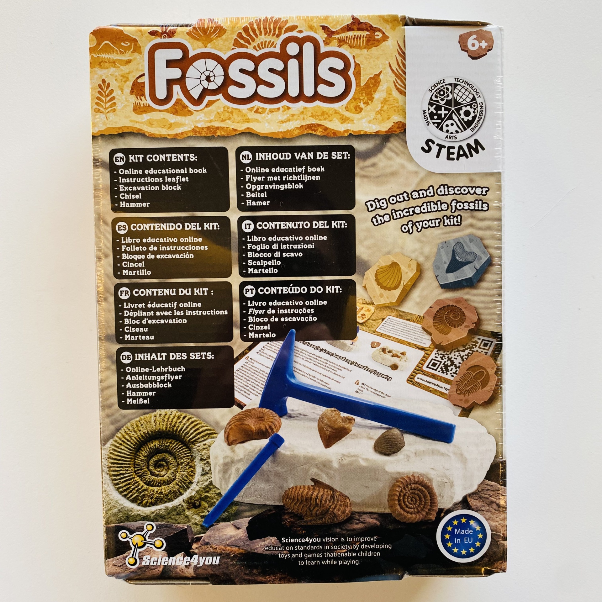 Caixa do kit educativo Fossils com ferramentas e fósseis com texto em várias línguas