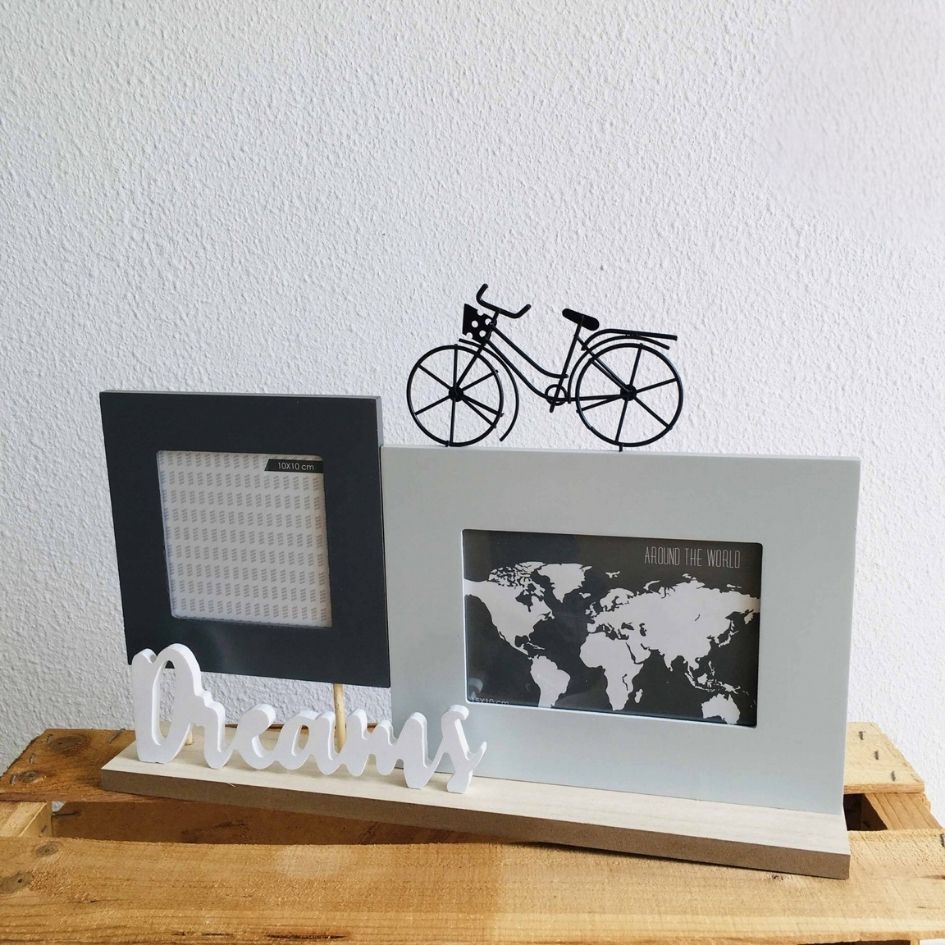 Porta-fotos com suporte de madeira, texto Dreams branco e bicicleta preta decorativa.