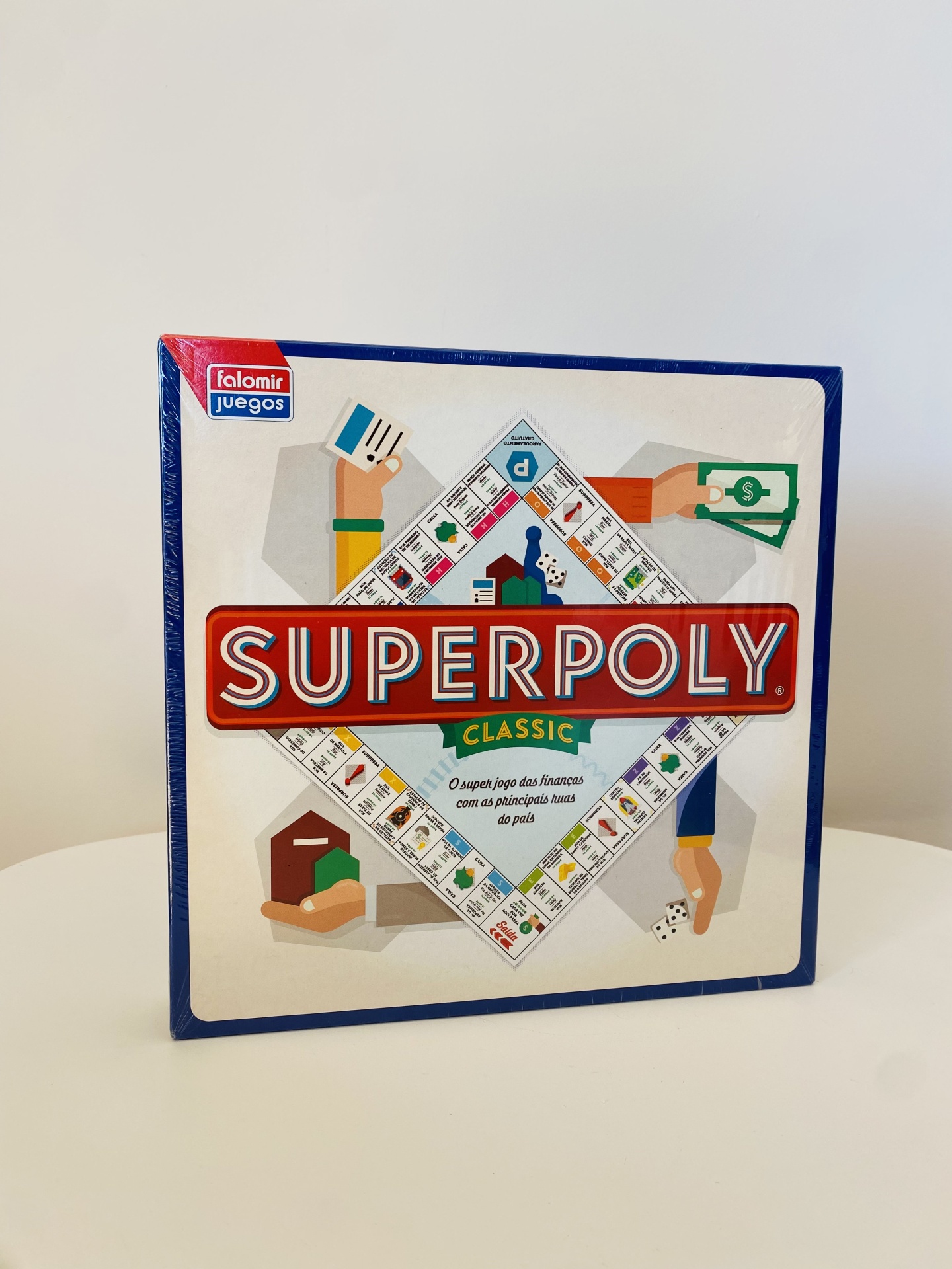 Caixa do jogo de tabuleiro Superpoly Classic com design colorido e texto legível