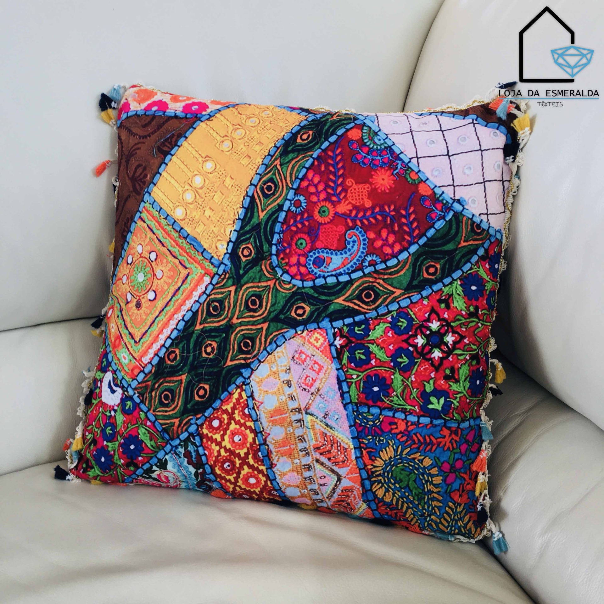 Almofada patchwork colorida num sofá de couro bege