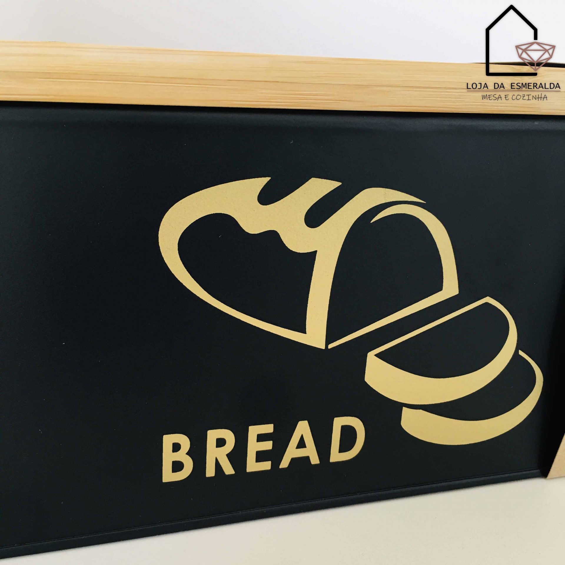Placa preta com desenho amarelo de pão e palavra BREAD