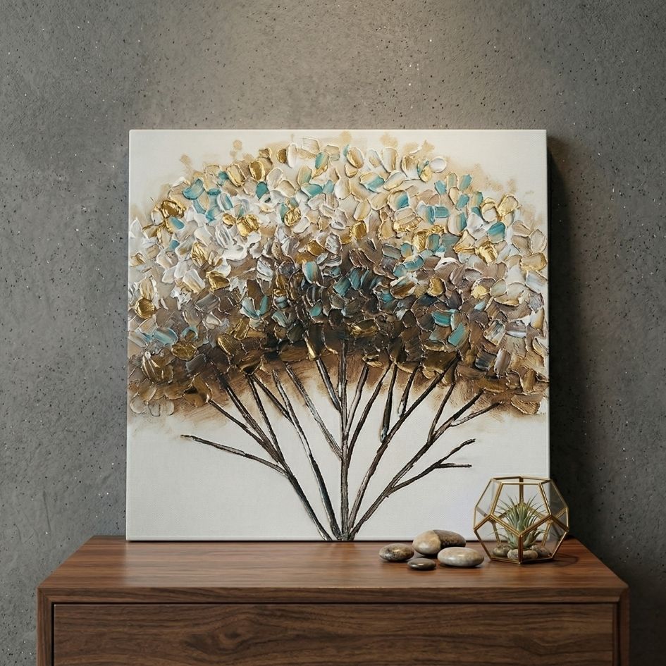 Quadro decorativo de árvore texturizada em tons claros sobre móvel de madeira