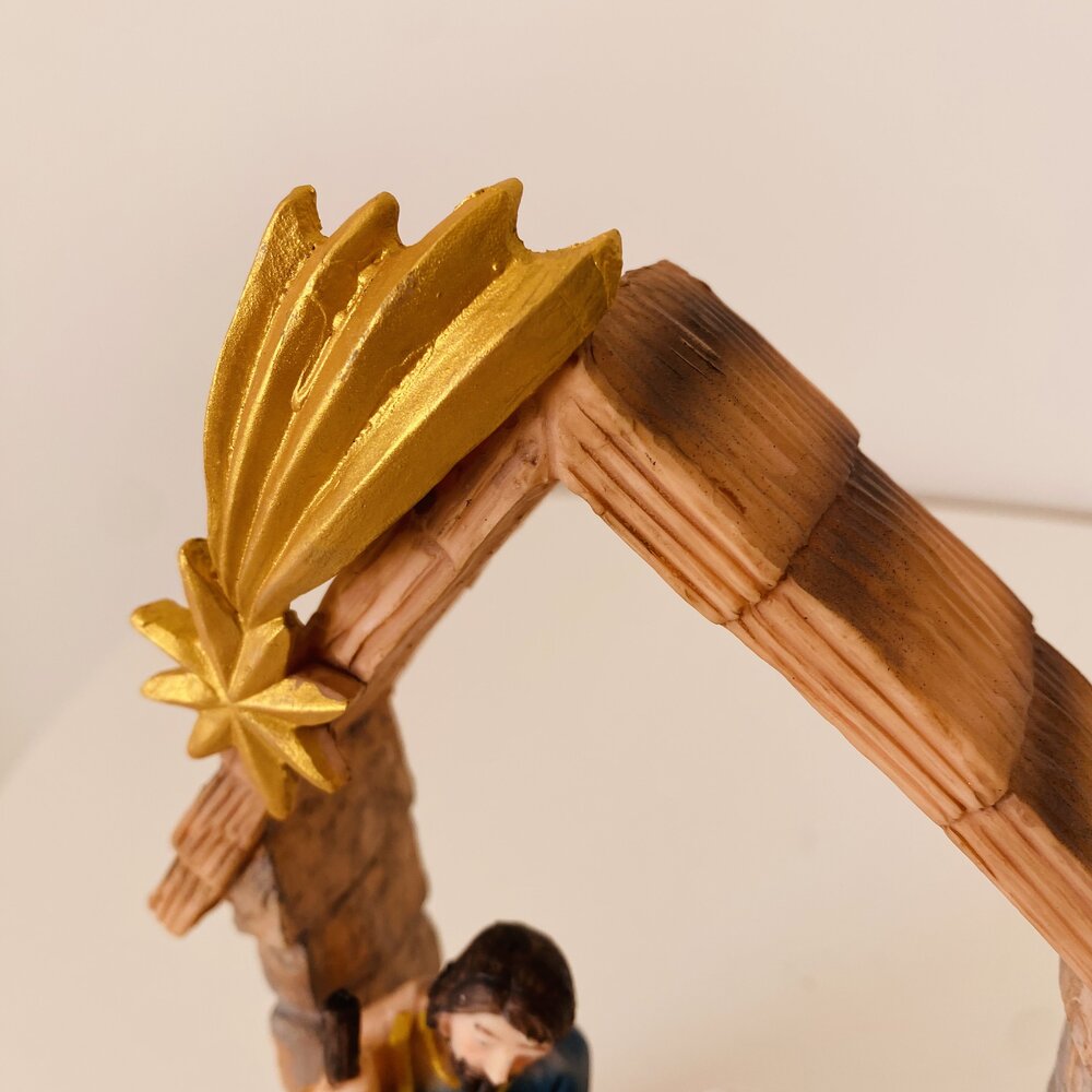 Presépio em miniatura de madeira com estrela dourada e figura humana