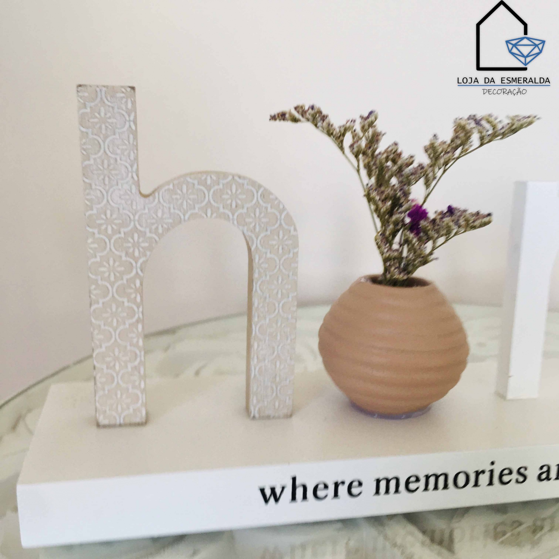 Letra decorativa 'h', vaso terracota com flores secas e base branca com texto