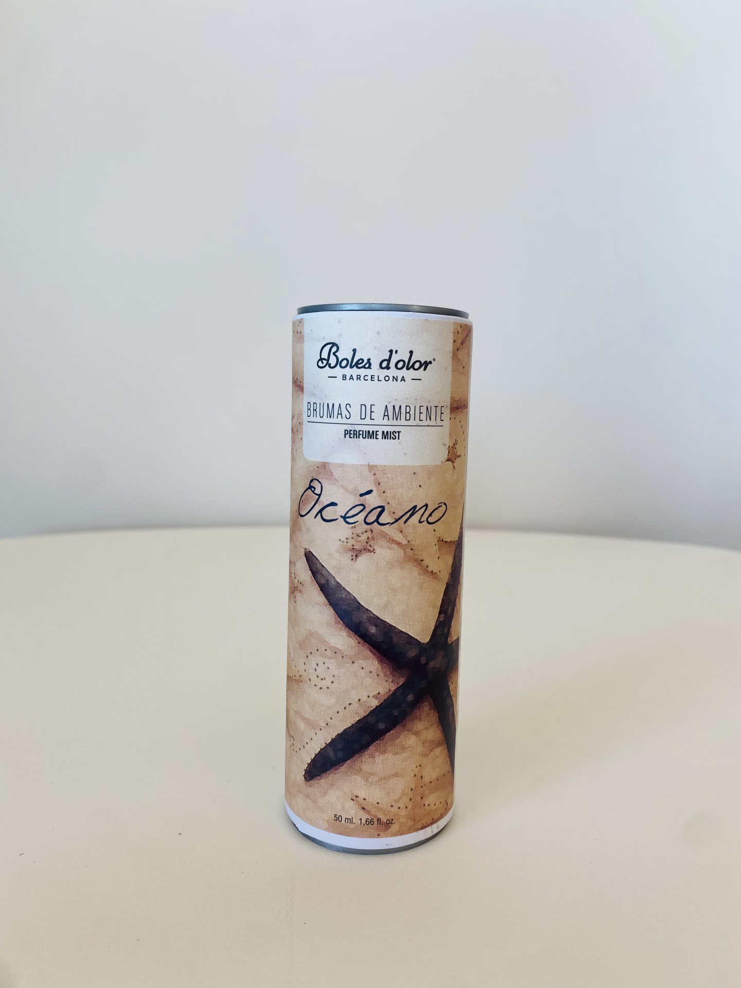 Frasco cylindrical para difusor de ambiente com ilustração de estrela-do-mar e texto 'OCEANO'.
