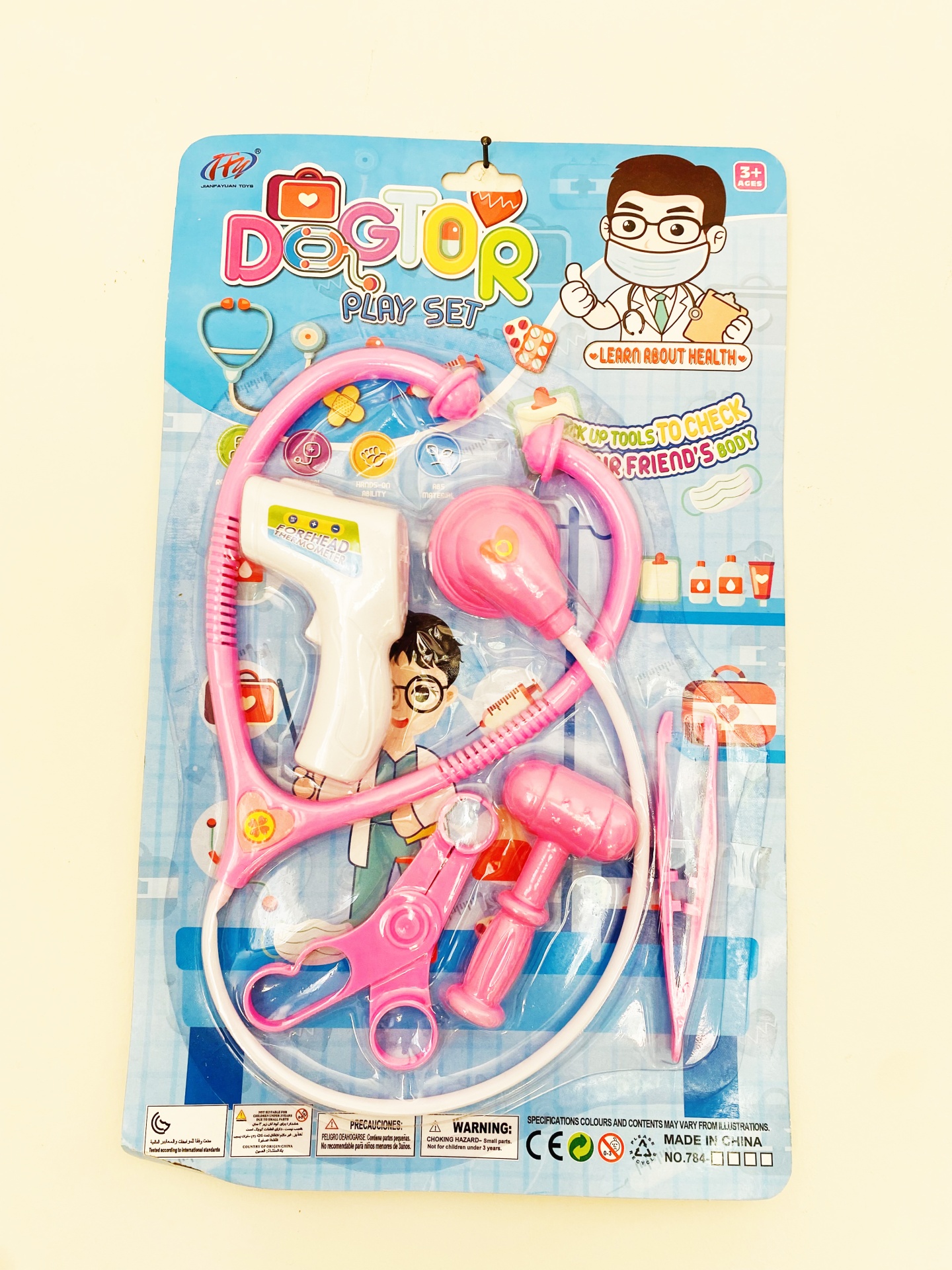 conjunto de brinquedo médico em cartão azul com acessórios cor de rosa