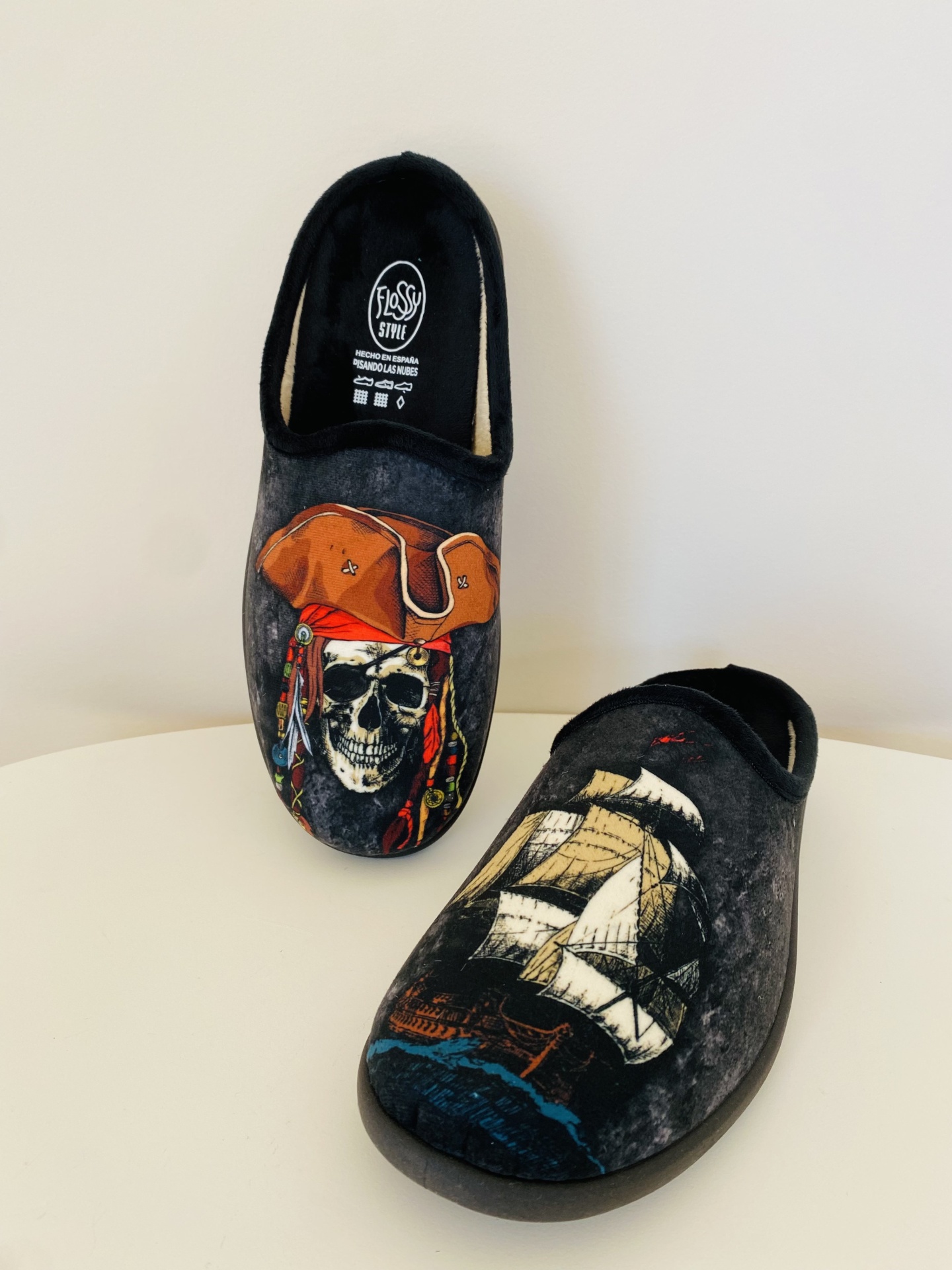 Par de chinelos pretos com desenhos de crânio pirata e navio pirata