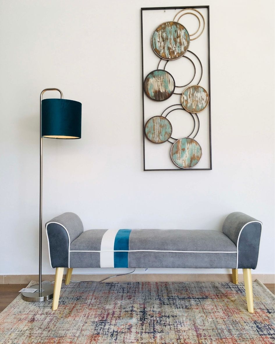 Banco cinza com detalhes em azul e branco e luminária azul ao lado