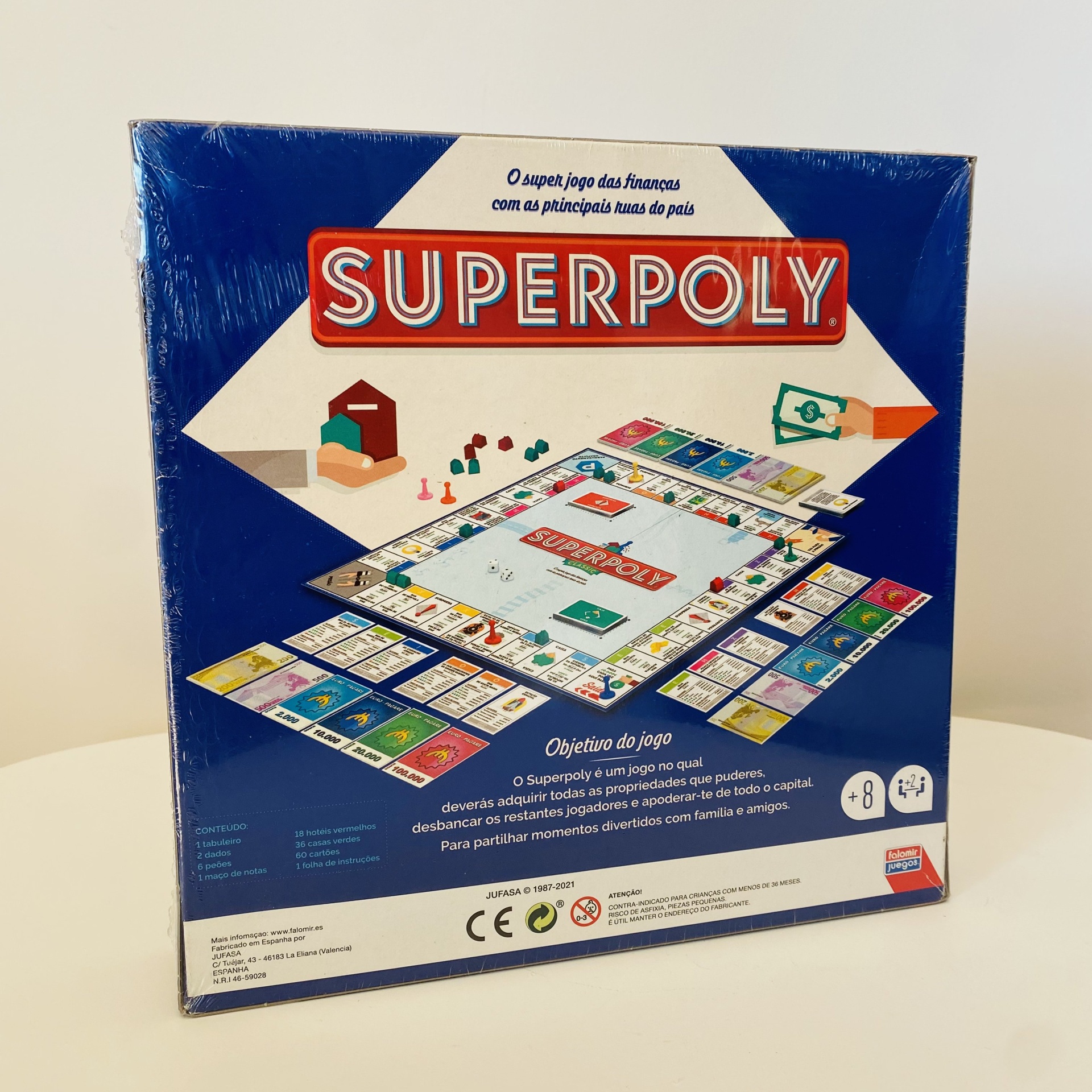 Embalagem azul do jogo SUPERPOLY com tabuleiro e peças coloridas
