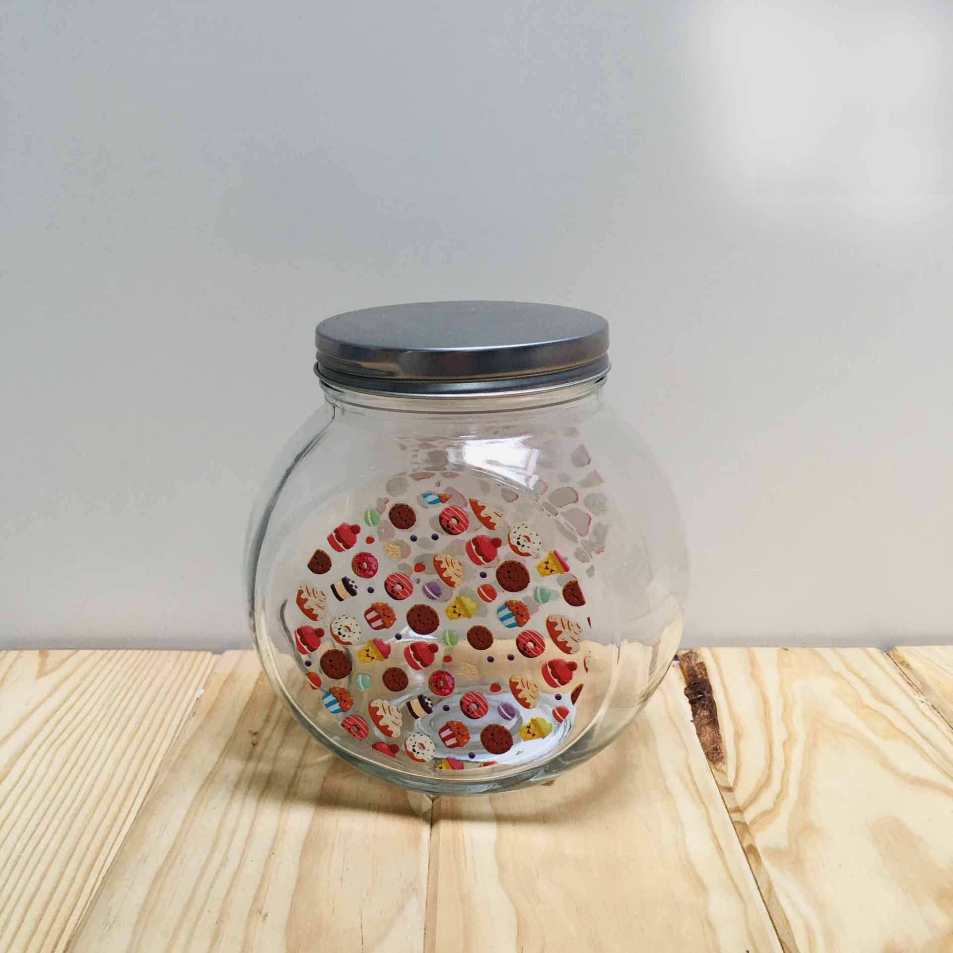 Frasco de vidro redondo com tampa metálica e padrão colorido dentro