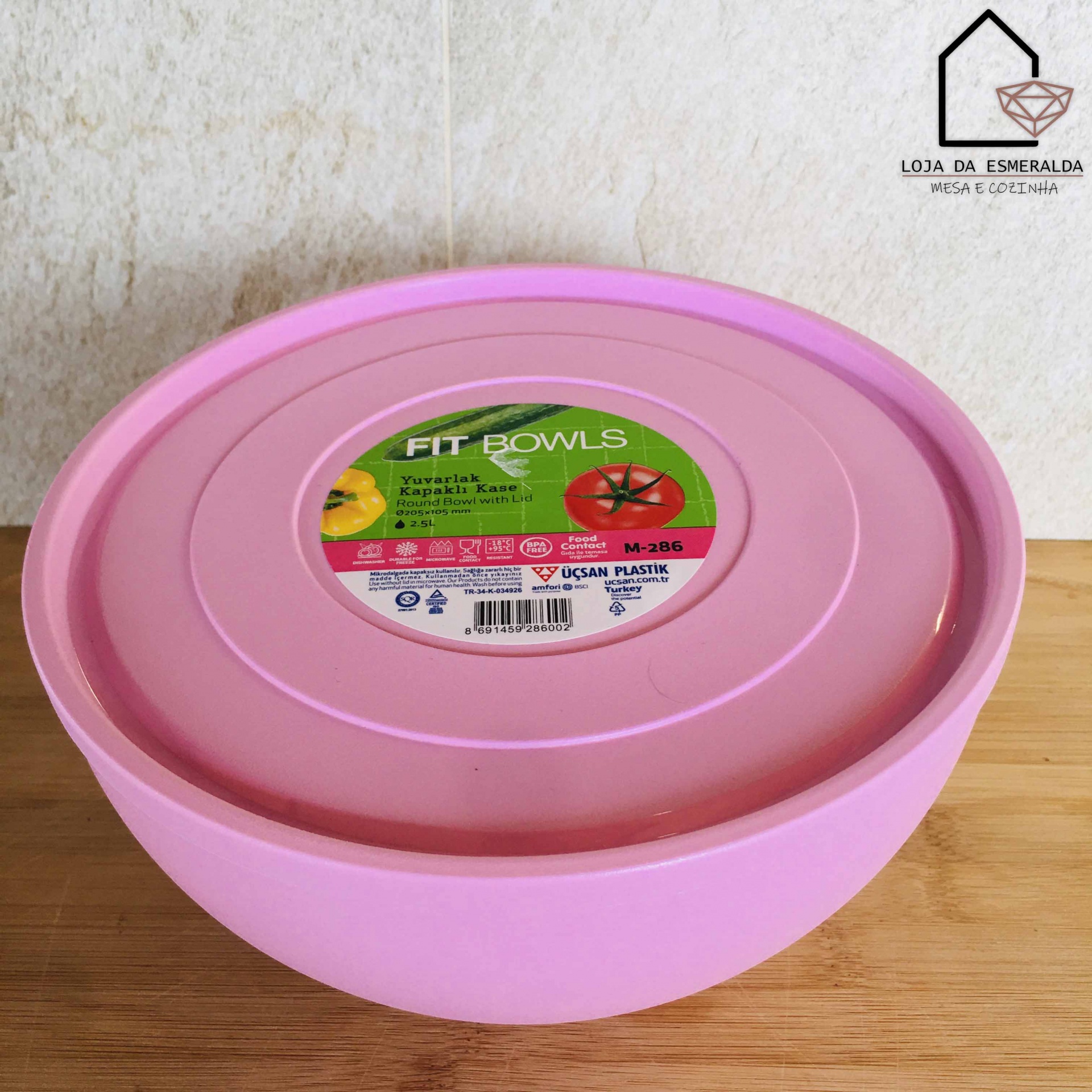 Tigela rosa com tampa e rótulo da marca FIT BOWLS em fundo claro