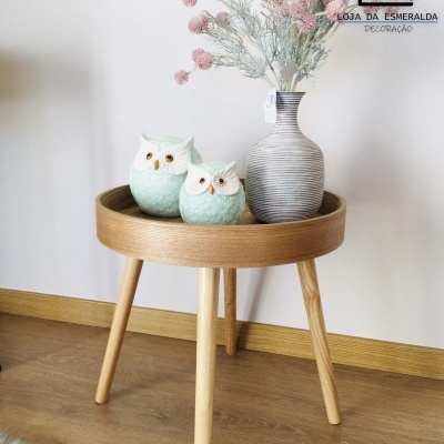 Mesa auxiliar redonda de madeira clara com vaso e duas corujas decorativas
